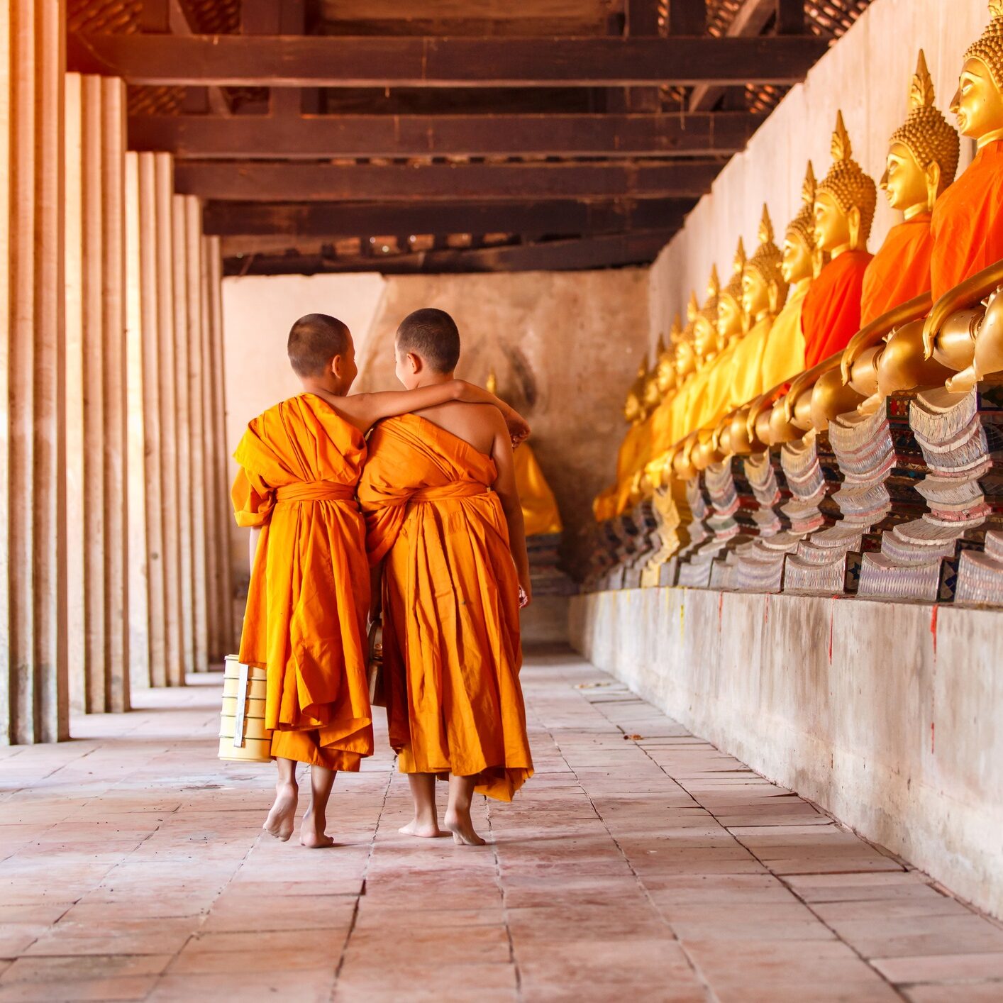 Two novices walking and talking in old temple at Ayutthaya Province, Thailand